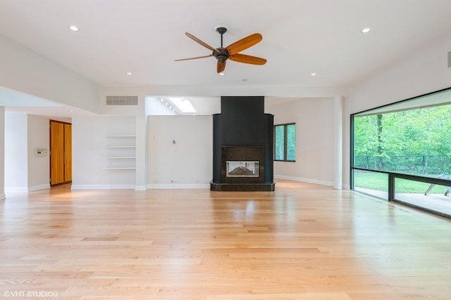 2000 Clendenin Ln, Riverwoods, IL 60015 - unfurnished living room with a ceiling fan, recessed lighting, built in features, light wood-style floors, and a large fireplace