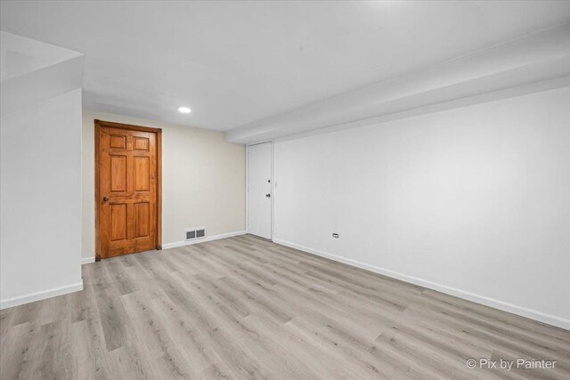 bathroom with toilet, a paneled ceiling, wood finished floors, and visible vents