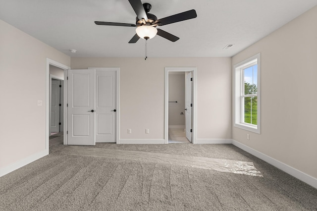 605 Wheatley Dr, Mahomet, IL 61853 - unfurnished bedroom with baseboards, carpet flooring, and ceiling fan