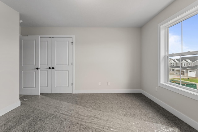 605 Wheatley Dr, Mahomet, IL 61853 - unfurnished bedroom with carpet flooring, baseboards, and a closet