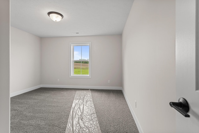 605 Wheatley Dr, Mahomet, IL 61853 - carpeted empty room featuring baseboards