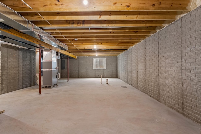605 Wheatley Dr, Mahomet, IL 61853 - basement with heating unit and brick wall