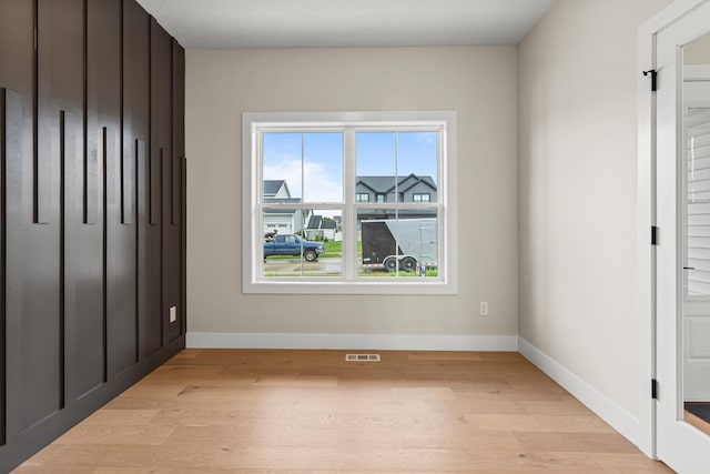 605 Wheatley Dr, Mahomet, IL 61853 - unfurnished bedroom with light wood-type flooring and baseboards