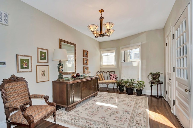 office space featuring dark wood-type flooring, visible vents, a notable chandelier, and baseboards