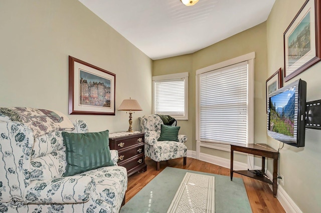 sitting room featuring baseboards and wood finished floors