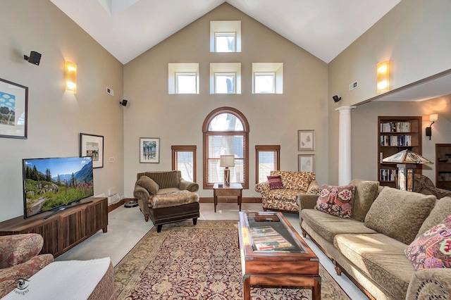 living room featuring visible vents, a wealth of natural light, decorative columns, and light colored carpet