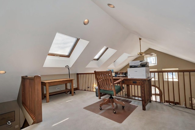 office area featuring lofted ceiling with skylight and carpet flooring