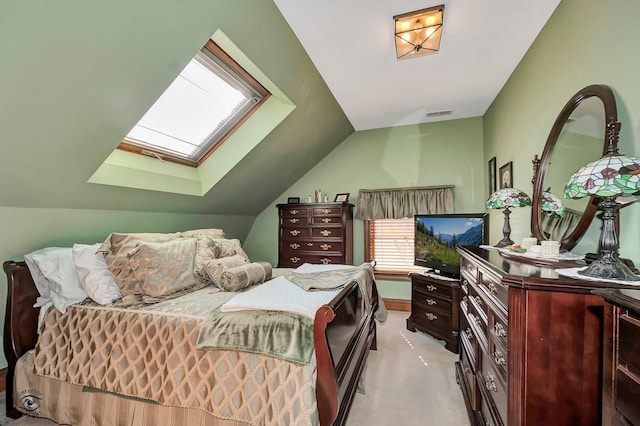 bedroom with carpet floors and vaulted ceiling with skylight