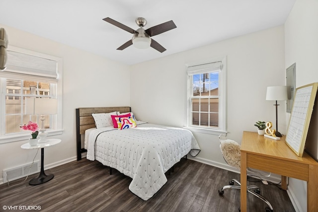 bedroom featuring visible vents, ceiling fan, baseboards, and wood finished floors