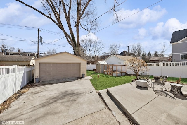 exterior space featuring an outdoor structure, fence private yard, and a garage