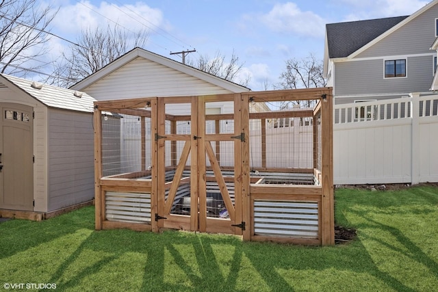 wooden deck featuring a yard, an outbuilding, and fence