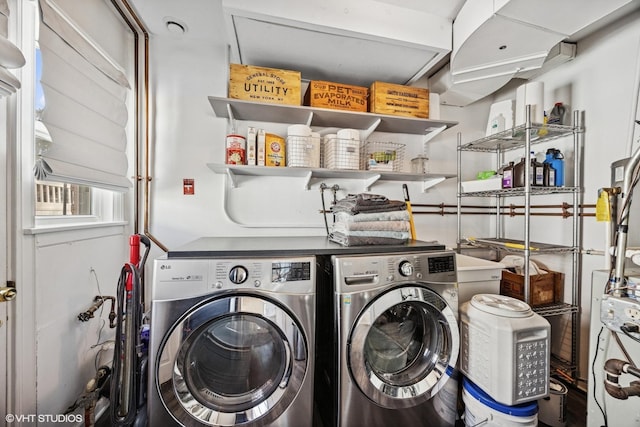 clothes washing area featuring laundry area and washer and clothes dryer