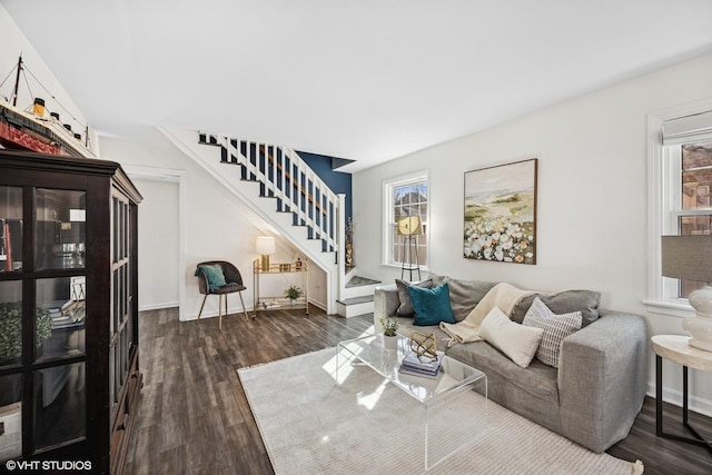 living area featuring dark wood-style floors and stairs