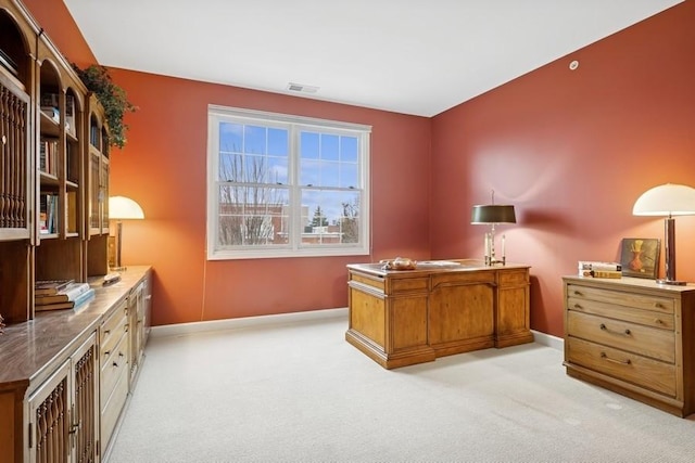 office area featuring light carpet, visible vents, and baseboards