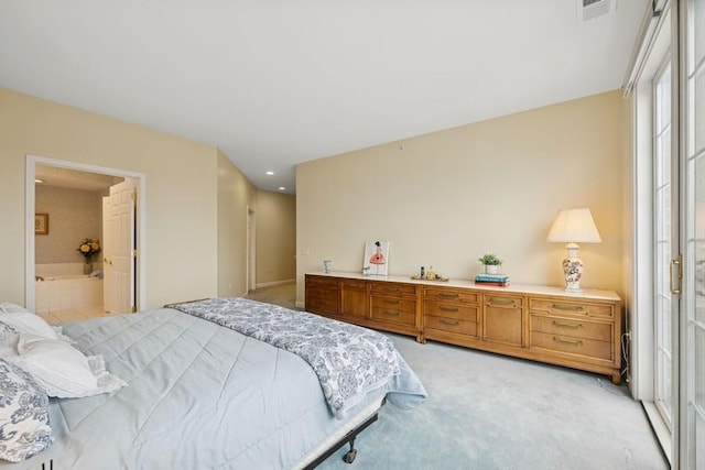 bedroom featuring ensuite bath, visible vents, and light colored carpet