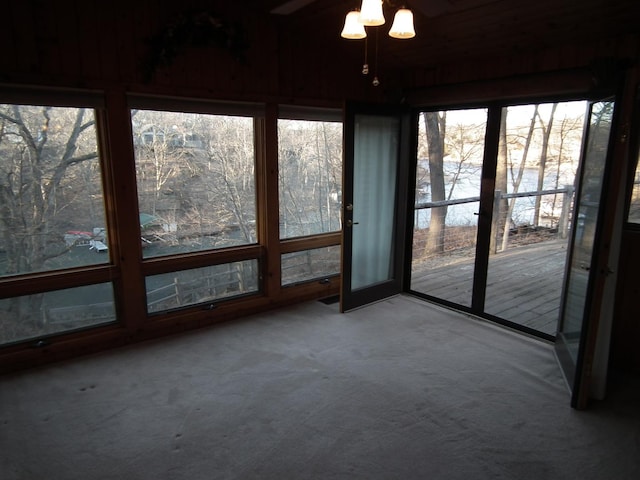 unfurnished sunroom featuring a wealth of natural light and ceiling fan