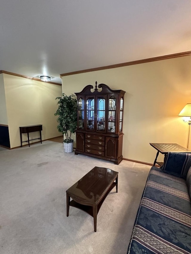 living room featuring ornamental molding, carpet, and baseboards