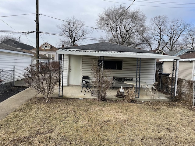 rear view of property with a patio area, fence, and a lawn