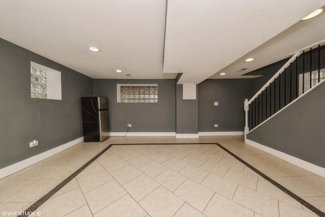 unfurnished room featuring stairway, recessed lighting, light tile patterned flooring, and baseboards