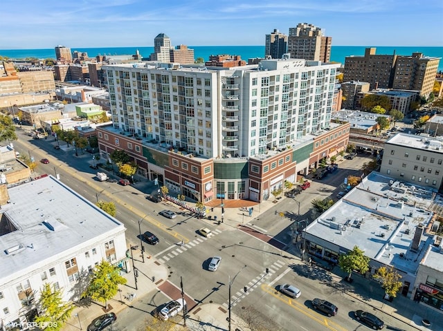 birds eye view of property featuring a water view and a view of city