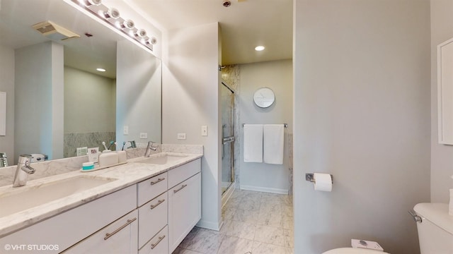 bathroom featuring marble finish floor, a stall shower, toilet, and a sink