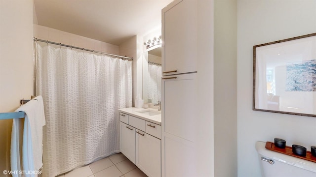 bathroom featuring vanity, tile patterned floors, and toilet