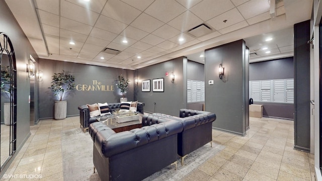 home theater room with visible vents, baseboards, a drop ceiling, mail area, and recessed lighting