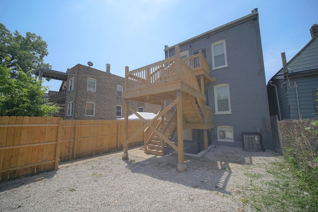 back of property featuring stairs, fence, cooling unit, a wooden deck, and brick siding