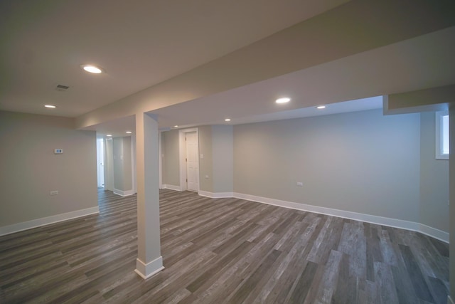 finished below grade area featuring recessed lighting, dark wood finished floors, and baseboards