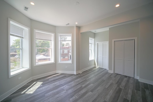 interior space with dark wood-style flooring, recessed lighting, visible vents, and baseboards