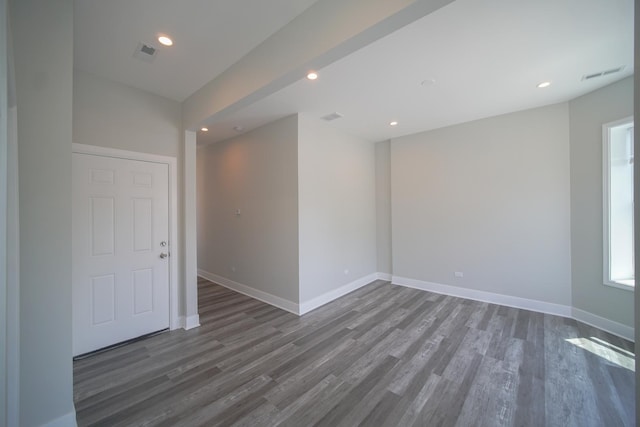 spare room featuring recessed lighting, wood finished floors, visible vents, and baseboards