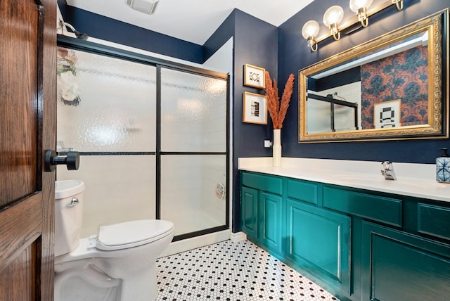 full bathroom featuring visible vents, toilet, a shower stall, vanity, and tile patterned floors