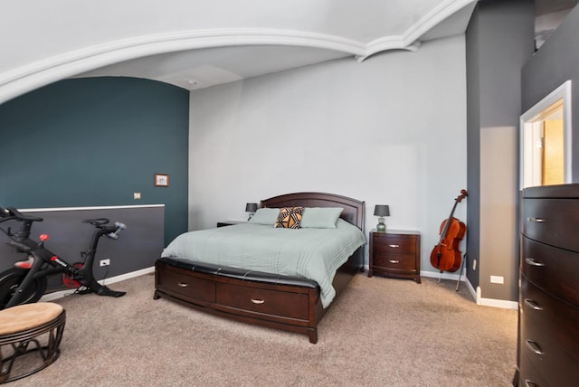 bedroom with light carpet and baseboards