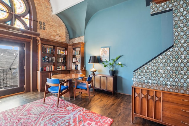 office area featuring wood finished floors and a towering ceiling