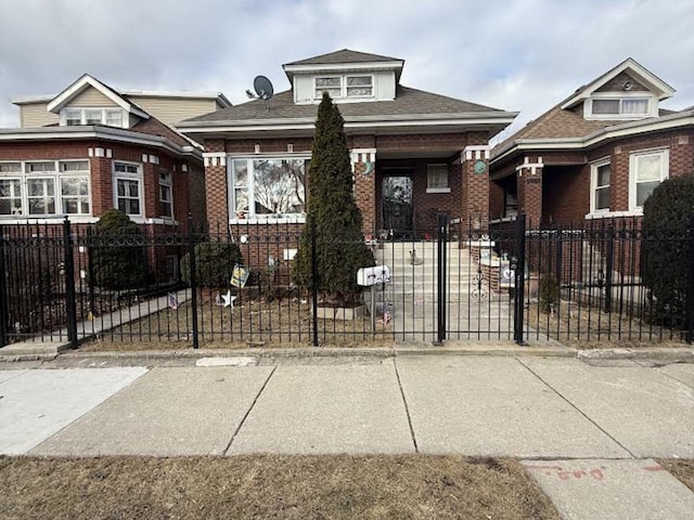 bungalow-style house with a fenced front yard and brick siding