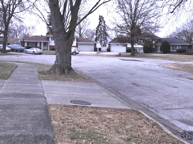 view of yard with a residential view and a detached garage