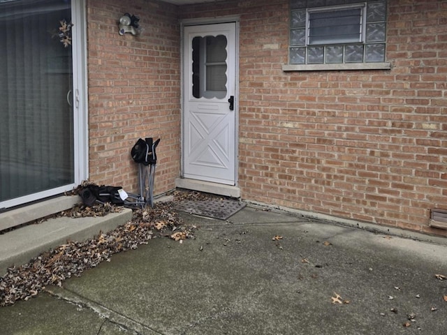 property entrance featuring brick siding