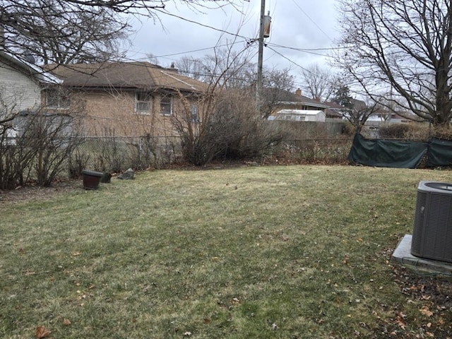 view of yard with fence and central air condition unit