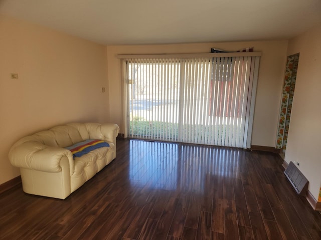 sitting room with visible vents, baseboards, and wood finished floors