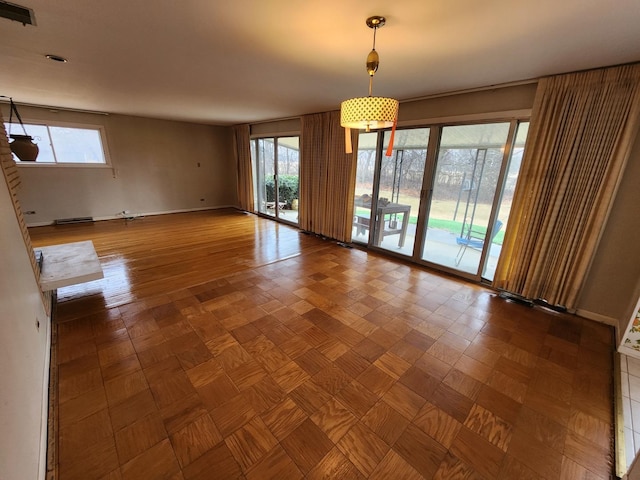 unfurnished room featuring visible vents and baseboards