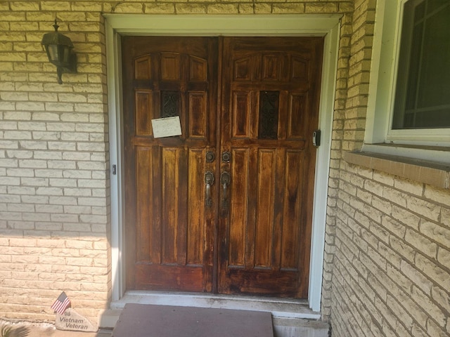 entrance to property with brick siding