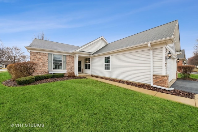 ranch-style house featuring aphalt driveway, brick siding, a garage, and a front lawn