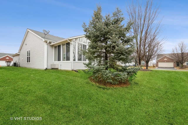 view of side of property with a yard