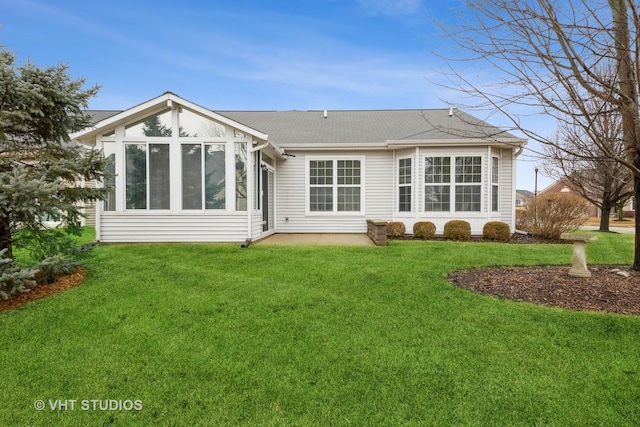 rear view of property featuring a yard