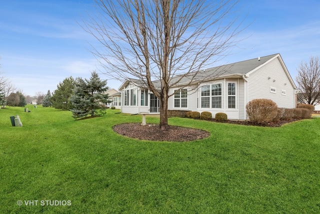 exterior space featuring a yard and a sunroom