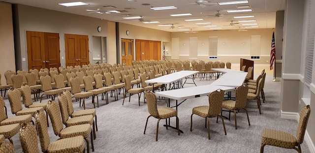 dining space featuring visible vents, baseboards, light colored carpet, and a ceiling fan