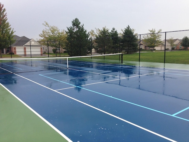 view of tennis court featuring fence