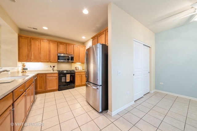 kitchen featuring visible vents, a sink, recessed lighting, stainless steel appliances, and light tile patterned floors