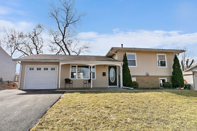 tri-level home featuring a front yard, an attached garage, and driveway