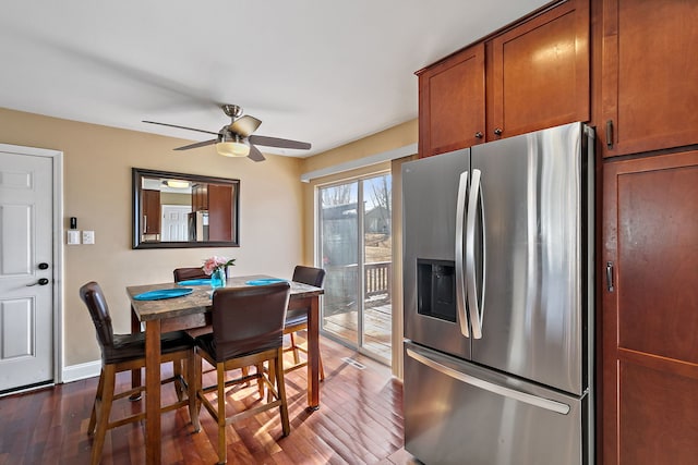 dining area featuring dark wood-type flooring, a ceiling fan, and baseboards